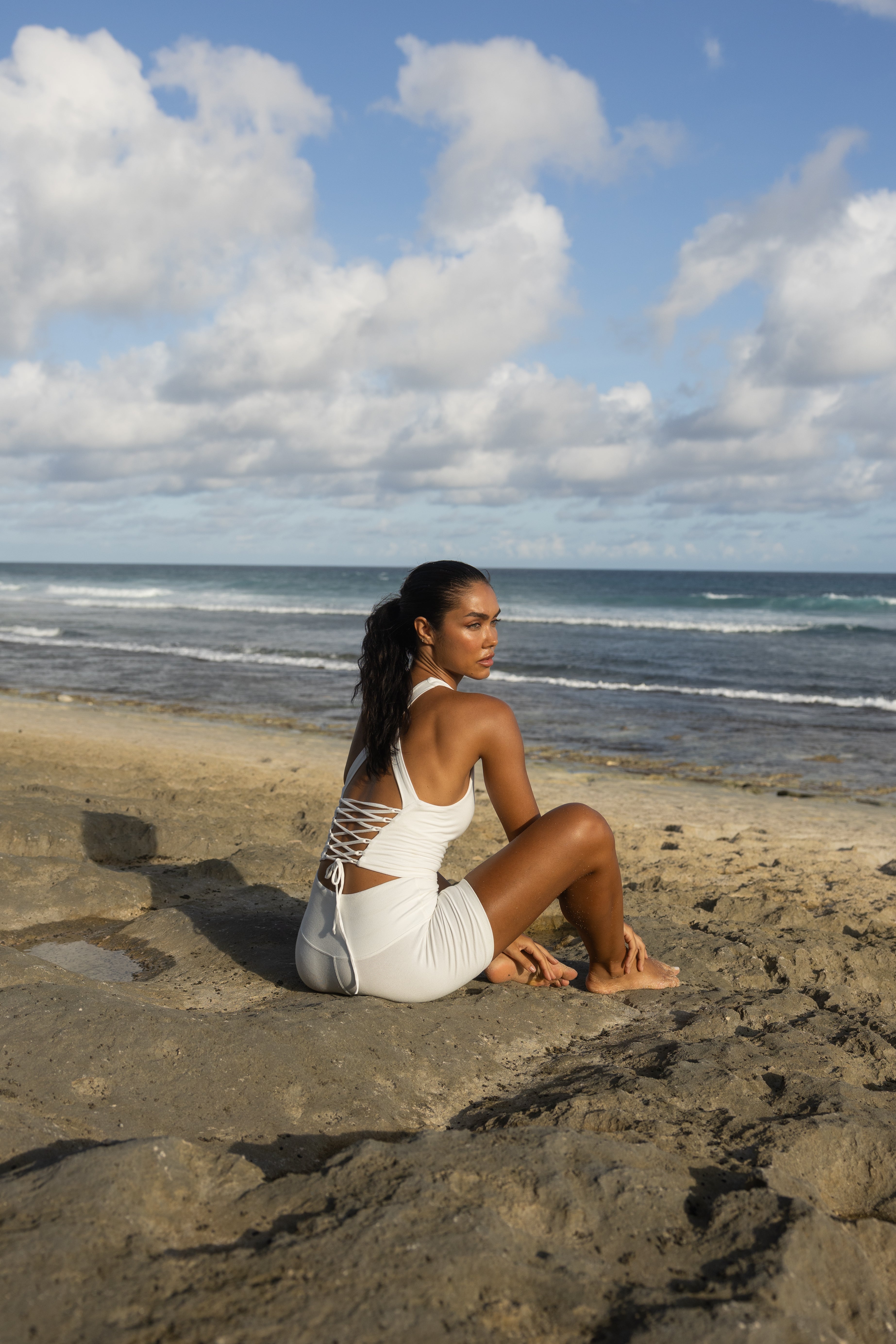 women wearing a soft bamboo open back tank top in a white color.