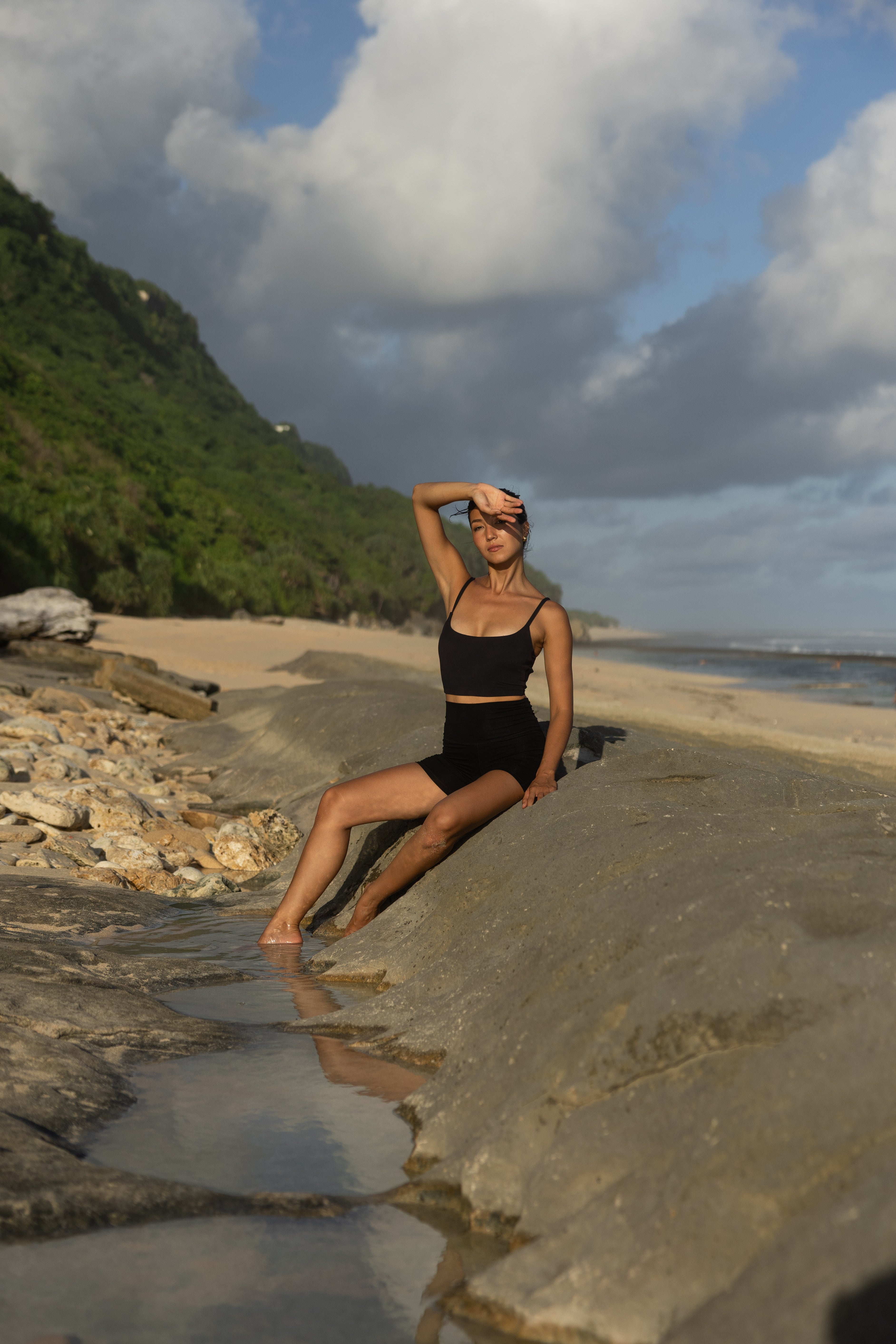 women in a black square neck sustainable sports bra.