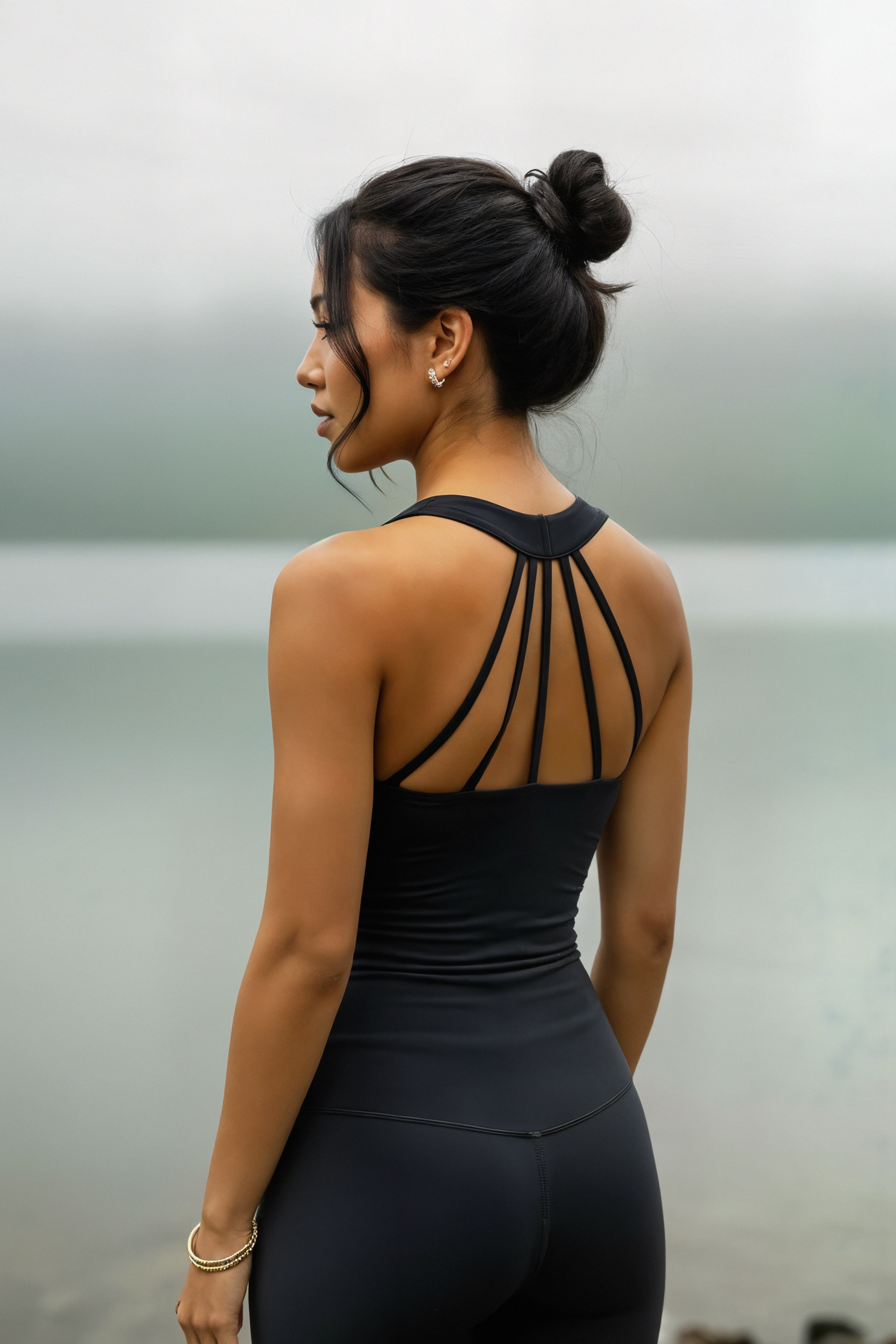 Woman wearing a midnight black strappy top bamboo leggings